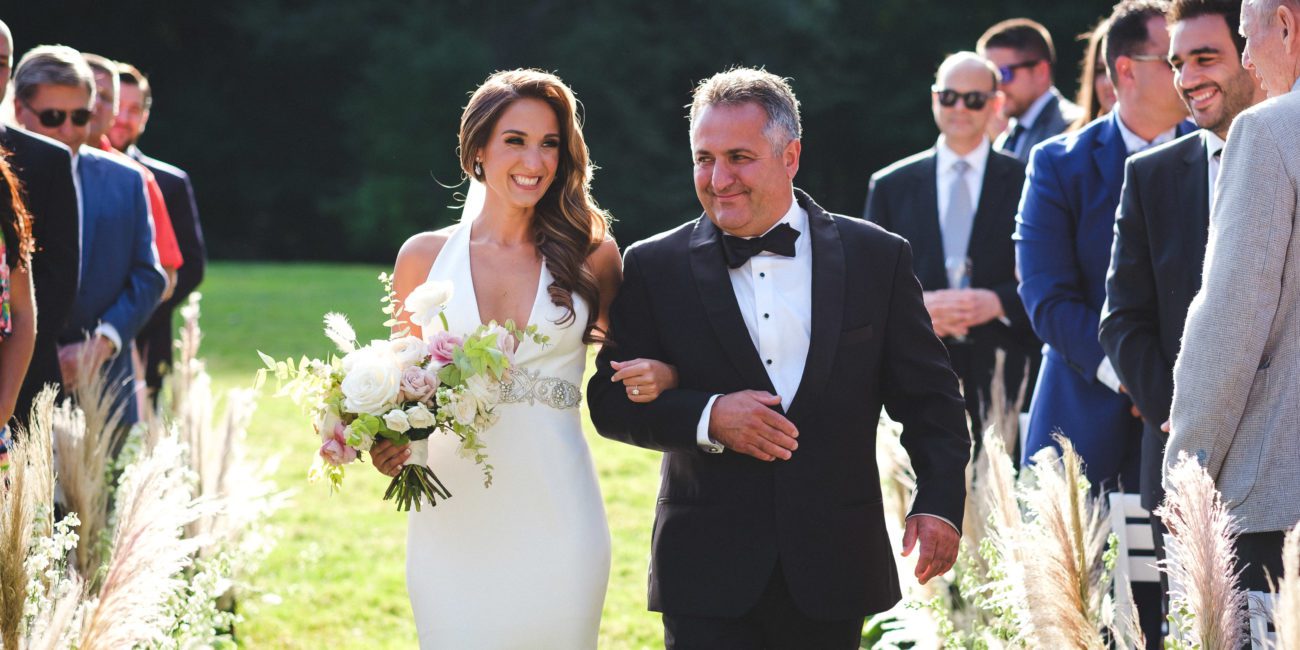 Bride is escorted down the aisle by her father.