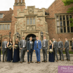Wedding party poses in front of Meadow Brook Hall