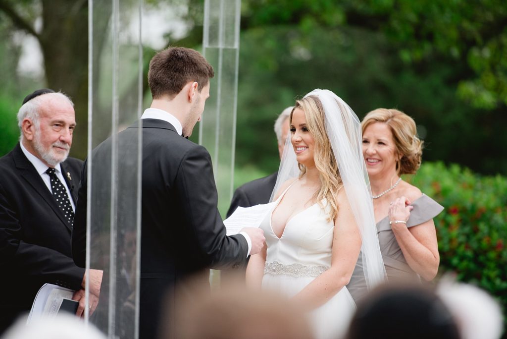 Bride and Groom exchange vows in wedding ceremony at Meadow Brook Hall