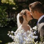 Bride and groom kiss on summer wedding day at Meadow Brook Hall