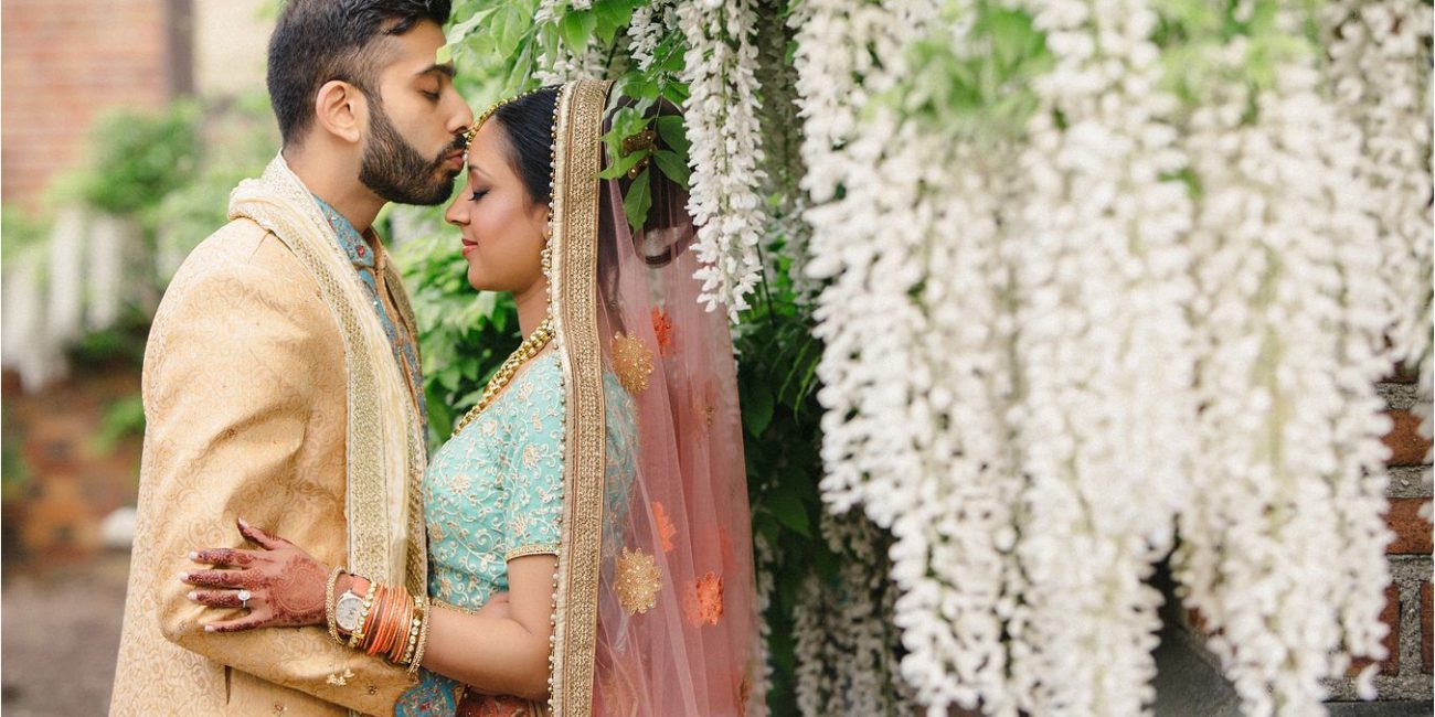 Indian Groom kisses his Bride's forehead at Meadow Brook.