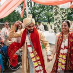 Indian couple celebrates at the end of their wedding ceremony at Meadow Brook Hall