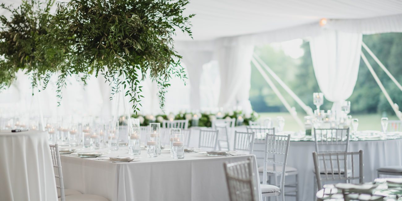 Elegant and modern table set up for a wedding inside the white garden tent
