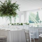 Elegant and modern table set up for a wedding inside the white garden tent