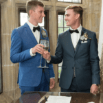 Two grooms cheers each other after getting married at Meadow Brook Hall