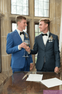 Two grooms cheers each other after getting married at Meadow Brook Hall