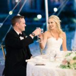 Couple cheers at their wedding reception