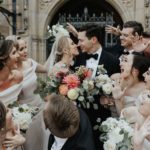 Wedding party gathers around bride and groom at Meadow Brook Hall