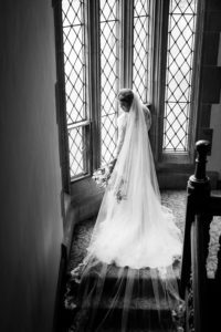 Bride gazes out gothic windows at Meadow Brook Hall