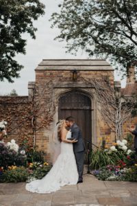 Bride and groom kiss at Meadow Brook Hall on their wedding day