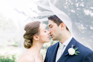 Bride and groom kiss on wedding day at Meadow Brook Hall