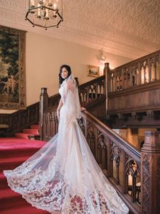 Bride poses on Meadow Brook Hall's Grand Staircase