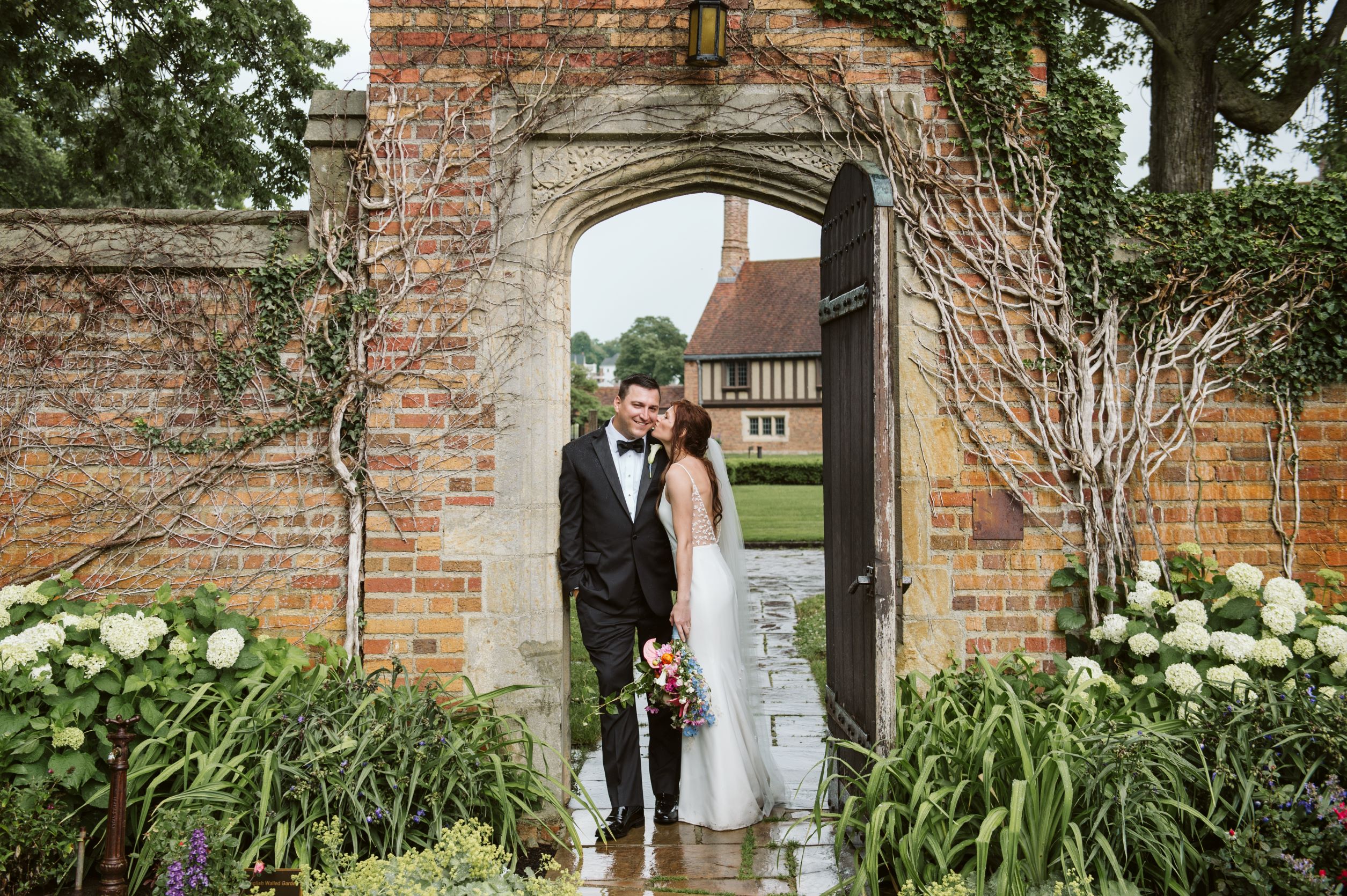 Bride and groom in English walled garden at Meadow Brook Hall