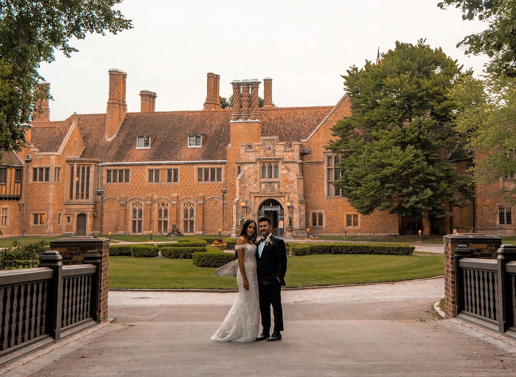 bride and groom in front of Meadow Brook Hall