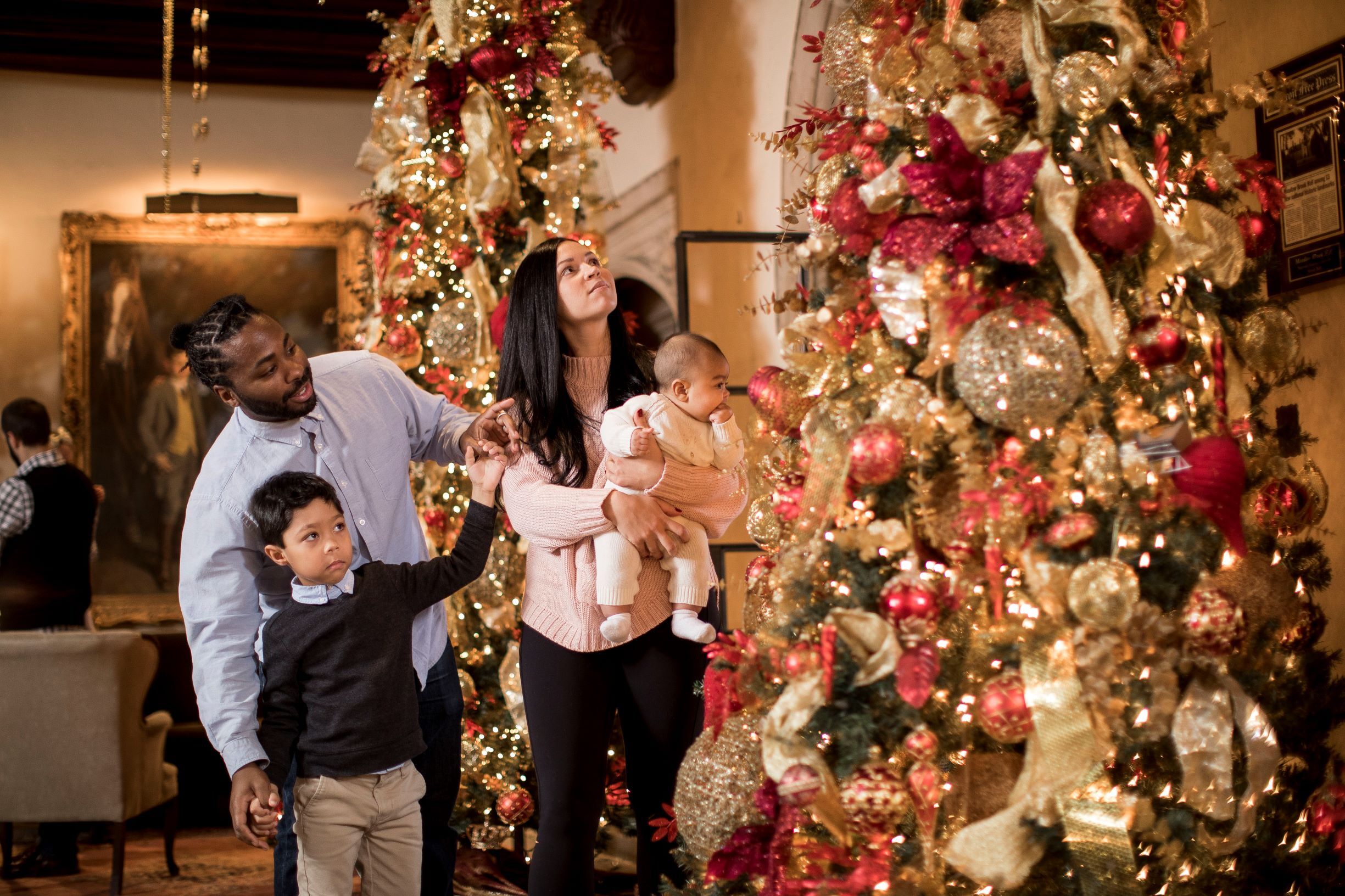 Family admiring decorated tree in Meadow Brook Hall
