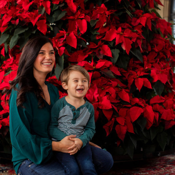 A woman and boy enjoy the holiday poinsettias