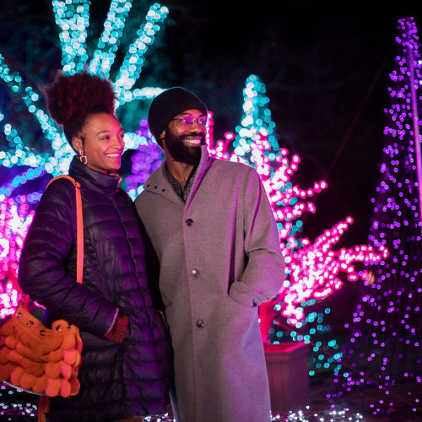 A man and a woman admire the winter wonder light displays outside Meadow Brook Hall