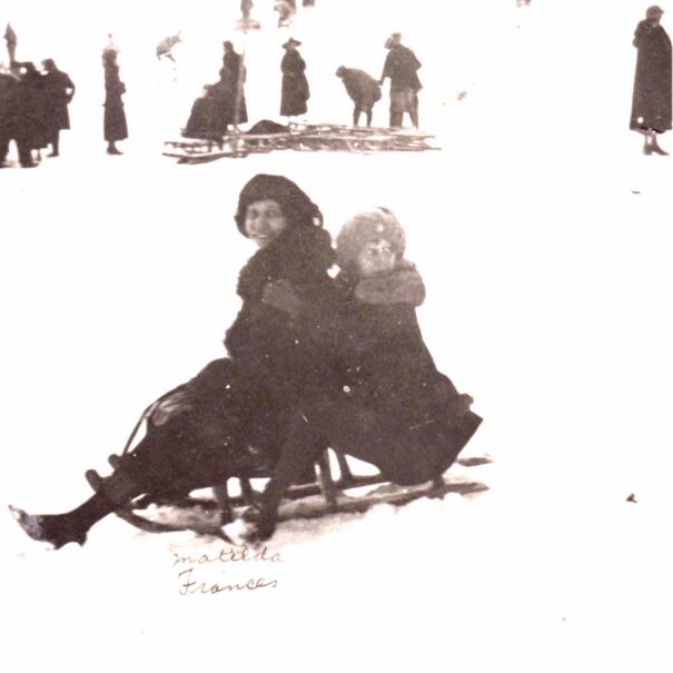 Matilda Dodge Wilson and Frances Dodge sledding in the winter.