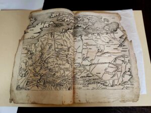 Meadow Brook Hall Curator Madelyn Chrapla researches a rare historic book, the Atlas Universal.