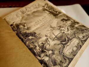 Meadow Brook Hall Curator Madelyn Chrapla researches a rare historic book, the Atlas Universal.