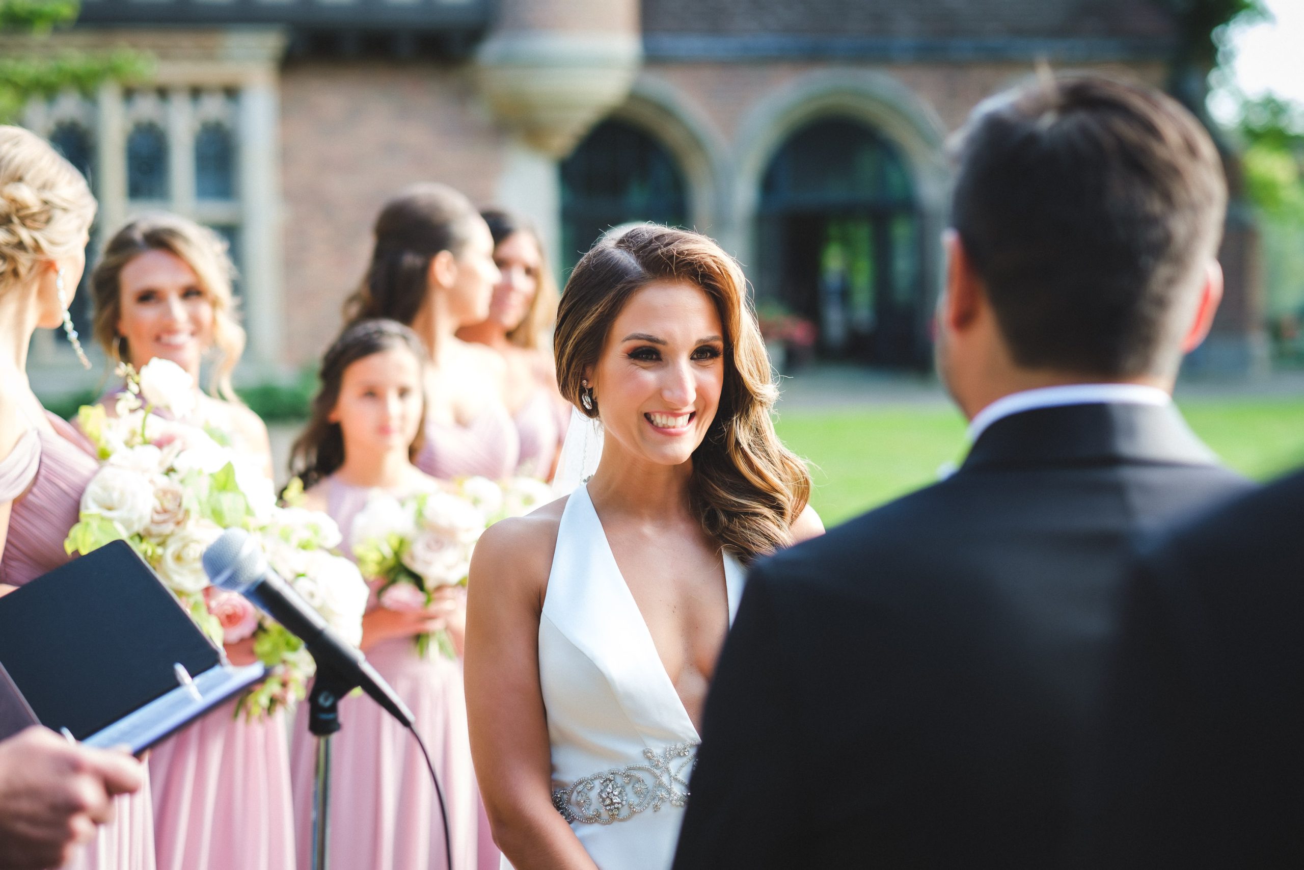 Bride looks at Groom during wedding ceremony at Meadow Brook Hall