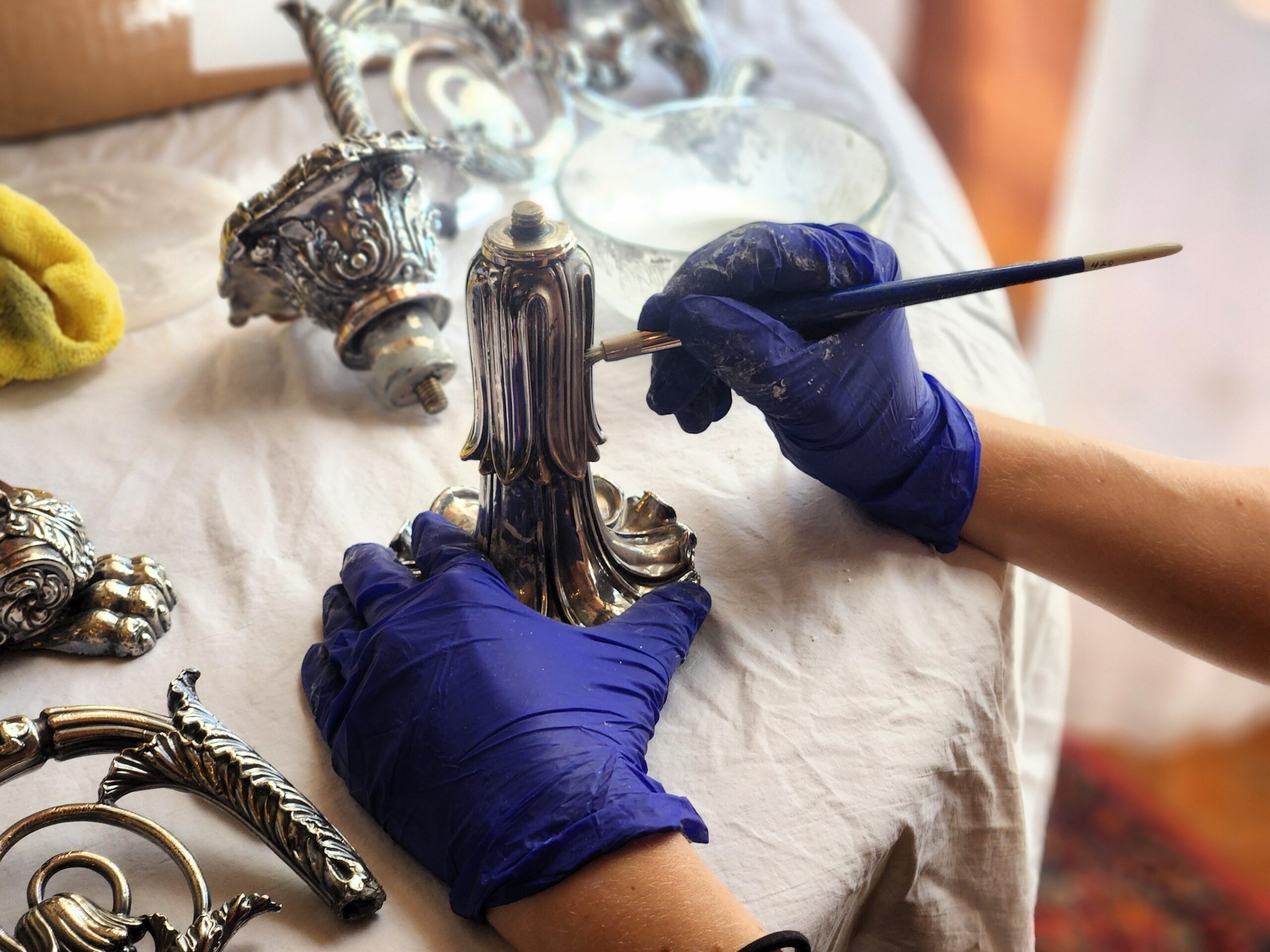 Volunteers at Meadow Brook Hall polish the historic silver.