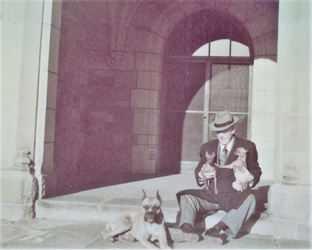 Alfred Wilson plays with his dogs at Meadow Brook Hall in the 1950s.