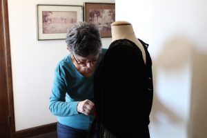 Costume-Volunteer-Work-Curitorial-20-scaled A Volunteer works on costume repairs at Meadow Brook Hall