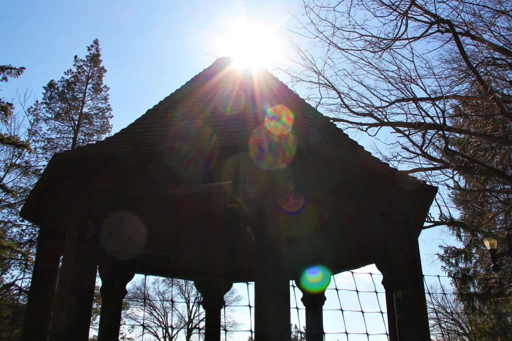 Sun flares over the gazebo at Meadow Brook Hall in early spring