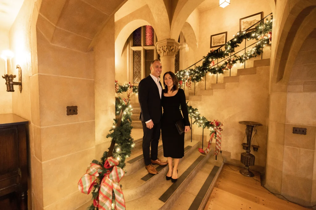 A couple enjoys an elegant holiday party at Meadow Brook Hall